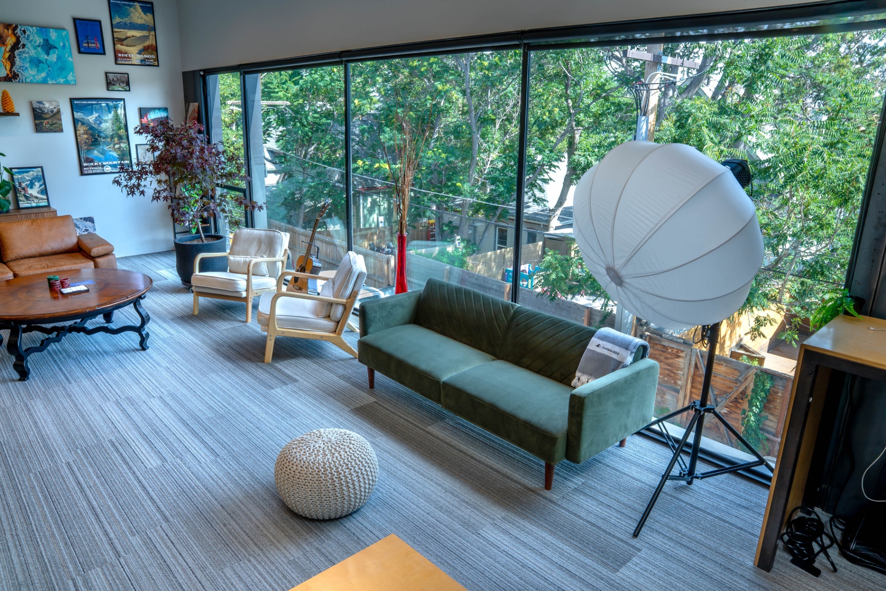 Second-floor Denver studio with green velvet sofa and softbox light