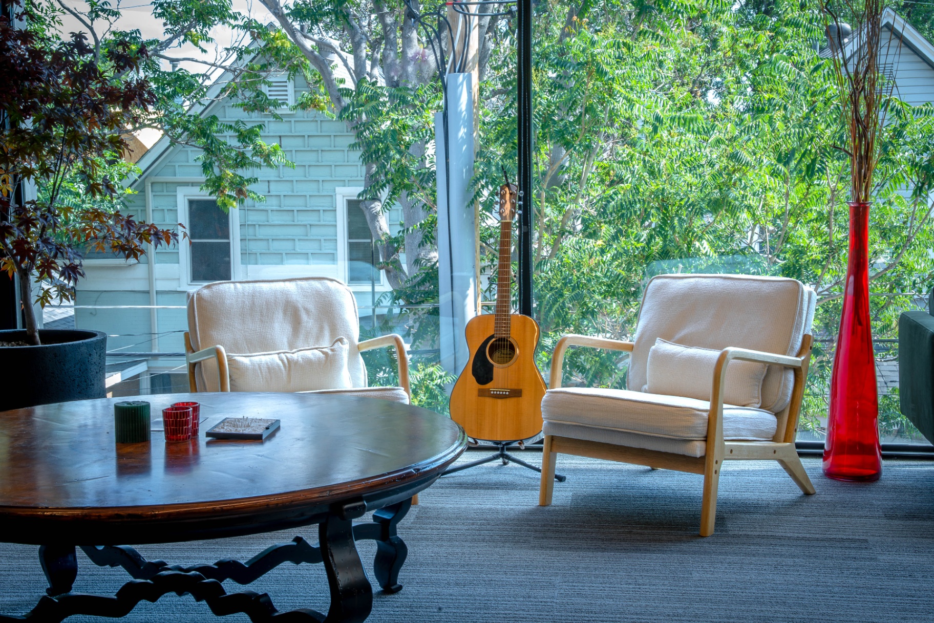 SageContent Denver studio lounge with acoustic guitar and large windows